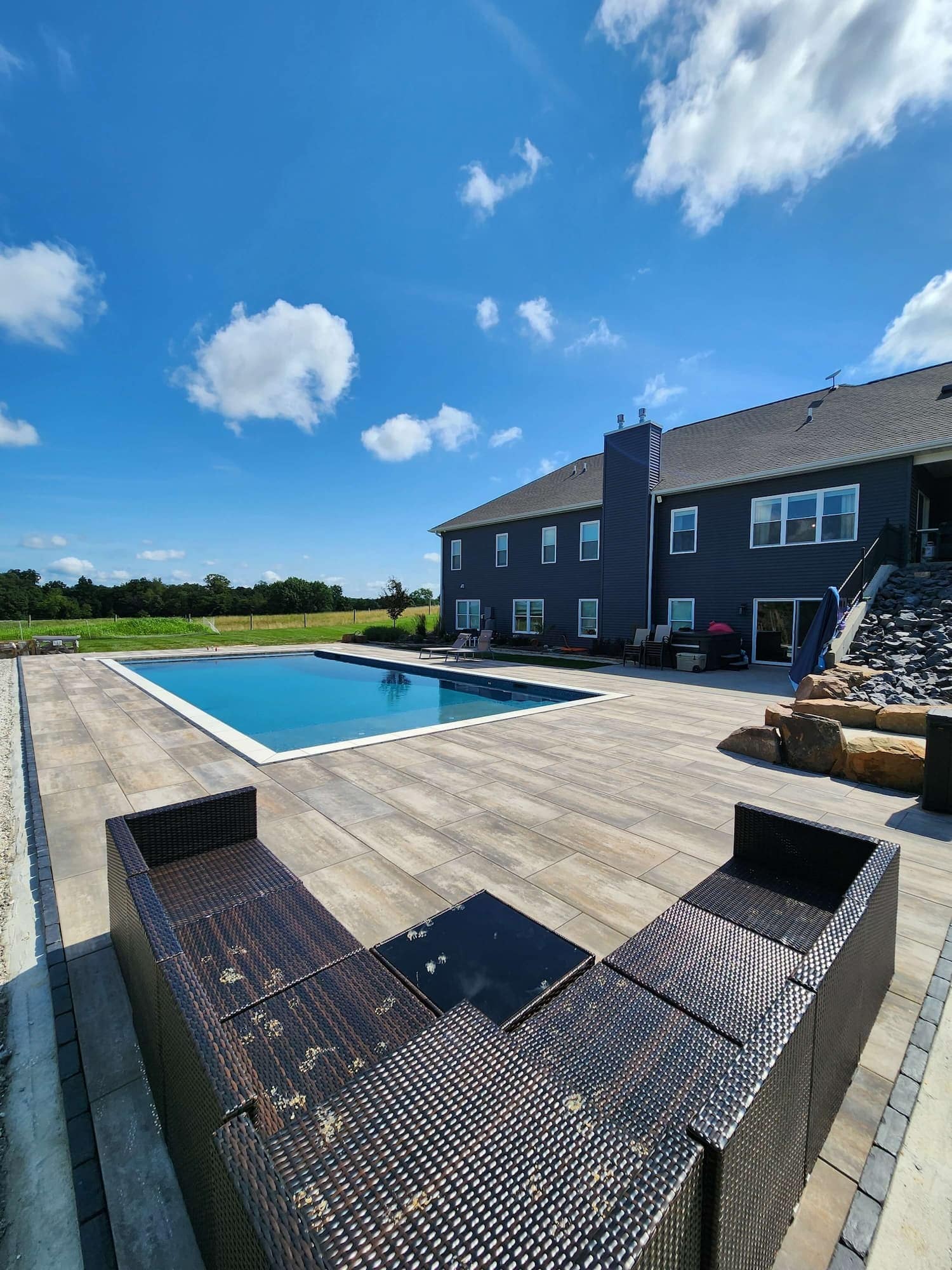 Outdoor Pool Surrounded by Tile and Blue Sky